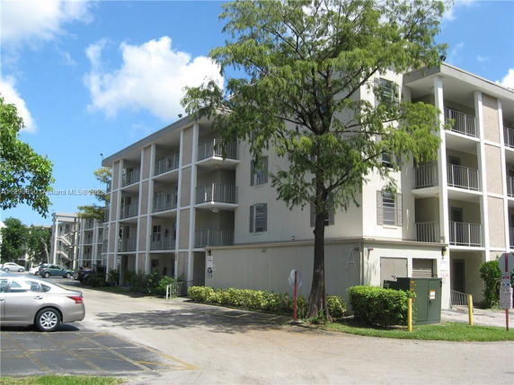 Front view of a multi-story residential building with balconies.