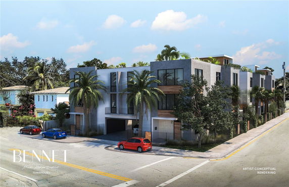 Front view of a modern townhouse complex with palm trees.