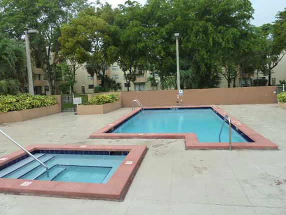 Outdoor swimming pool area with a main pool and a smaller adjacent pool.