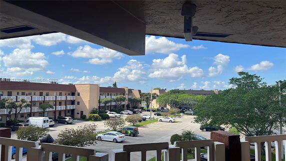 Panoramic view of apartment buildings and parking area.
