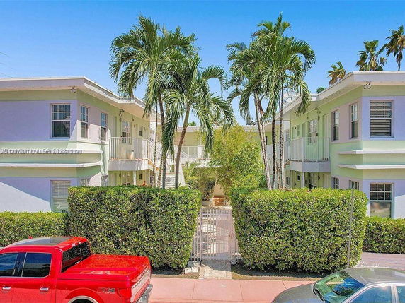 Front view of a two-story apartment building with pastel-colored exterior.
