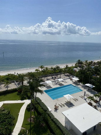 Aerial view of a swimming pool area next to a beach.