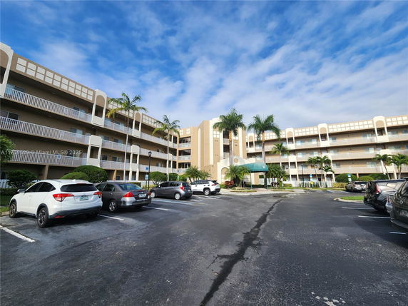 Front view of a multi-story apartment building with balconies.