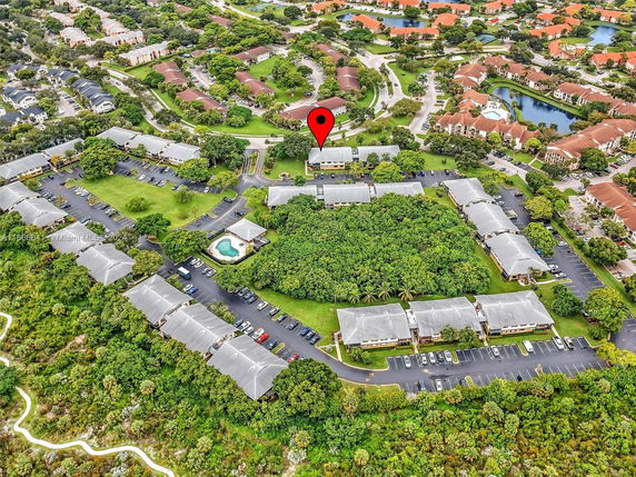 Panoramic view of a residential complex with multiple buildings and parking areas.