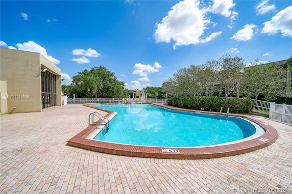 Outdoor swimming pool with surrounding patio area.