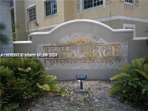Front view of a building with a decorative sign reading 'VILLA TRACE CONDOMINIUM'.