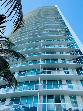 Front view of a high-rise building with multiple balconies.