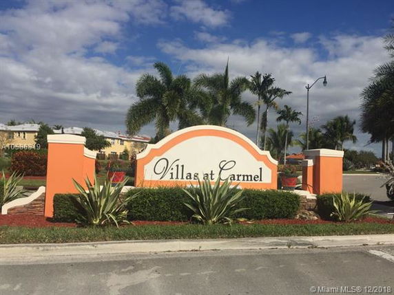 Front view of Villas at Carmel entrance with a decorative sign.