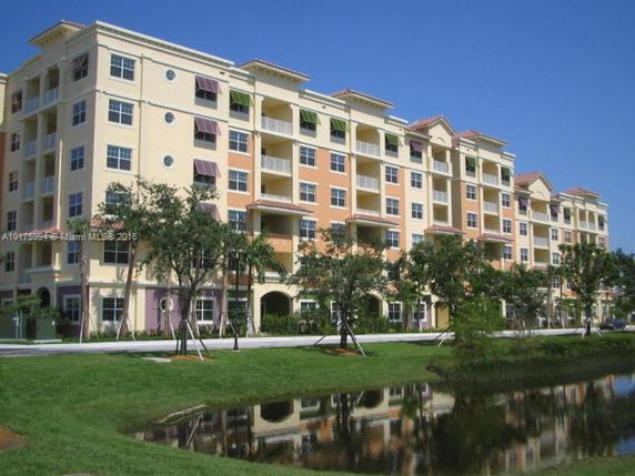 Front view of a multi-story residential building with balconies.