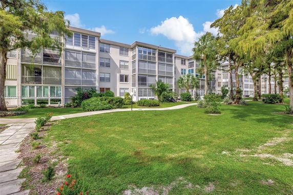 Front view of a multi-story apartment building with multiple balconies.