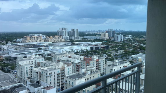 Panoramic view from a high vantage point overlooking a cityscape with multiple buildings.