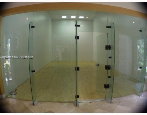 Indoor squash or racquetball court with glass walls.