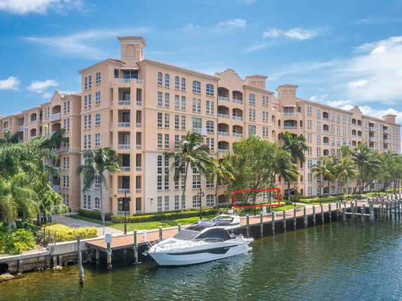 Front view of a multi-story residential building by the waterfront.