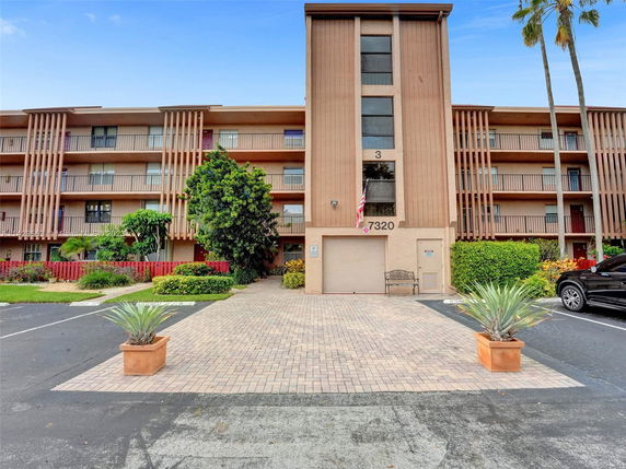 Front view of a multi-story residential building with balconies.