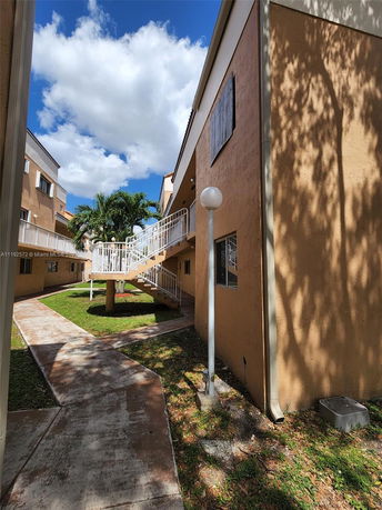 Front view of a multi-story residential building with exterior staircases.