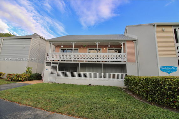 Front view of a two-story residential building with a balcony.