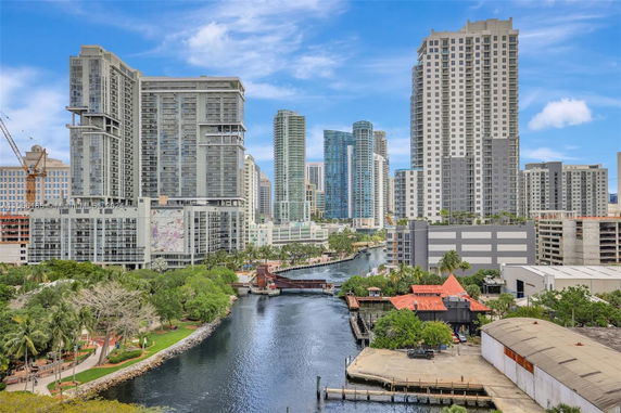 View of multiple high-rise buildings next to a waterway.
