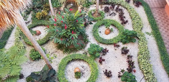 Decorative garden with plants and clay pots arranged in circular patterns.