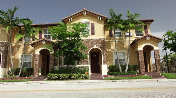 Front view of a two-story house with stone and stucco exterior.