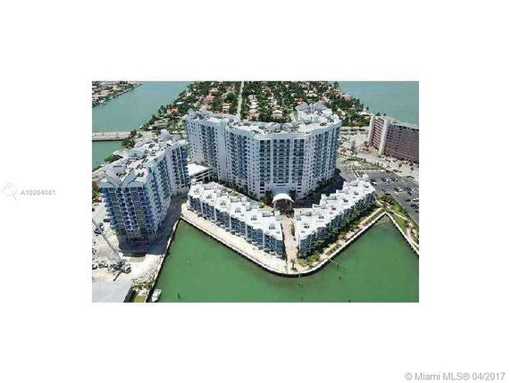 Aerial view of a large waterfront condominium complex with multiple high-rise buildings.
