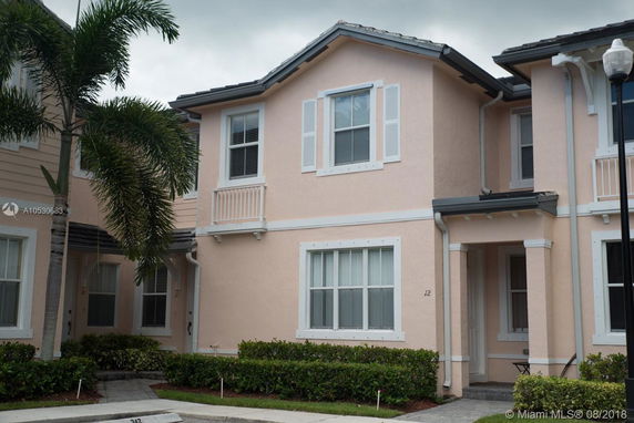 Front view of a two-story townhouse with peach-colored exterior.