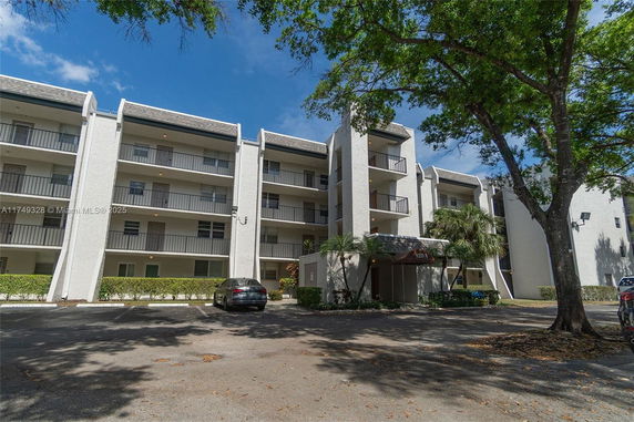 Front view of a multi-story residential building with balconies.