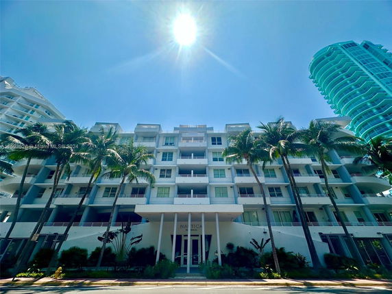 Front view of a multi-story residential building with balconies.
