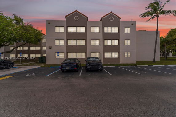 Front view of a multi-story building with symmetrical design and multiple windows.