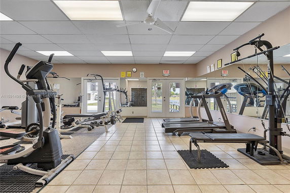 Indoor gym area with exercise equipment and mirrored walls