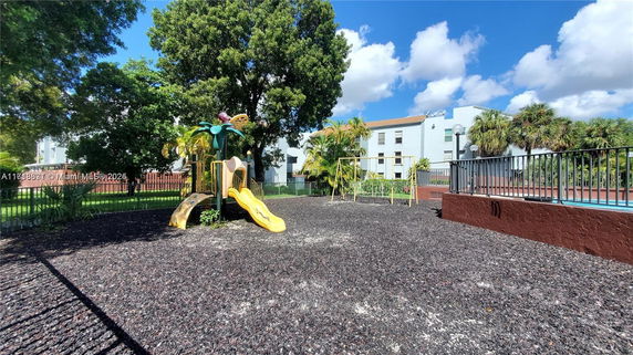 Outdoor playground with a slide and swings.