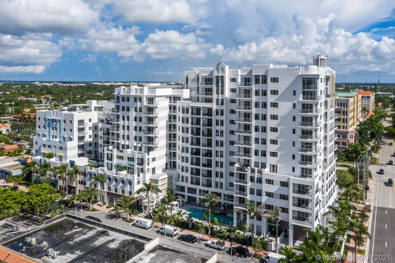 Front view of a multi-story residential building with balconies and a modern design.