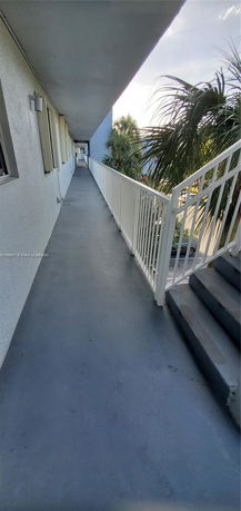 Exterior walkway of a building with railings and steps.