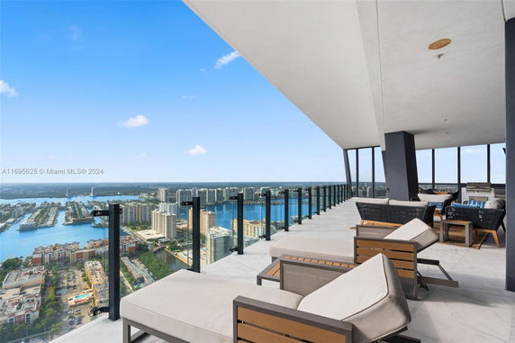 Outdoor balcony with panoramic view of cityscape and waterfront.