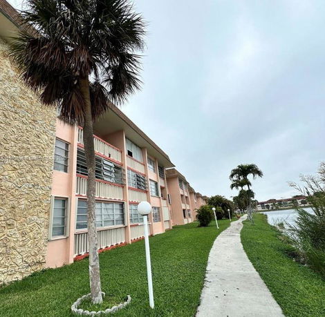Side view of a multi-story apartment building with balconies.