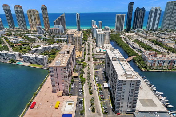 Aerial view of high-rise buildings with ocean in the background.