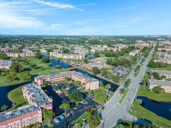 Aerial view of multiple residential buildings and a road.