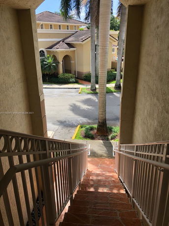 View of a building with a tiled roof seen from a stairway.