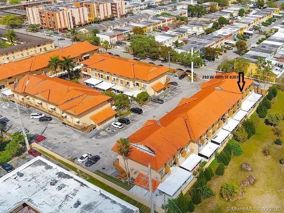 Aerial view of a residential complex with orange roofs.