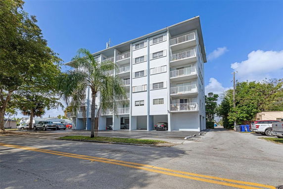 Front view of a multi-story apartment building with balconies.