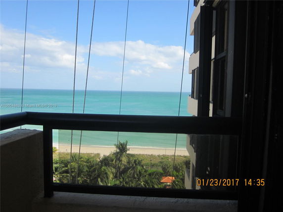 View of the ocean from a high-rise building balcony.
