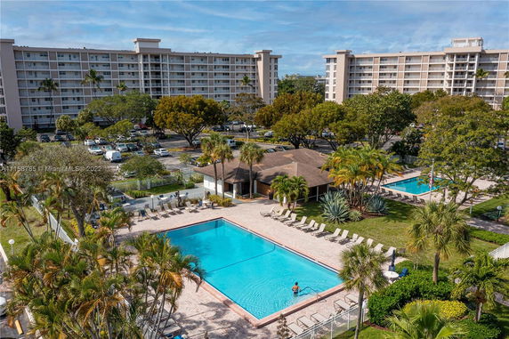 Mid-rise residential buildings with two swimming pools in the foreground.