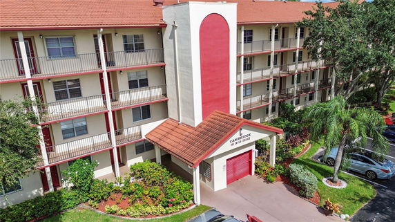 Front view of a multi-story residential building with balconies.