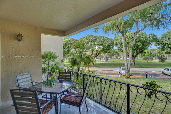 Outdoor patio with a view of a grassy area and trees