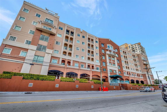 Front view of a multi-story residential building with balconies.