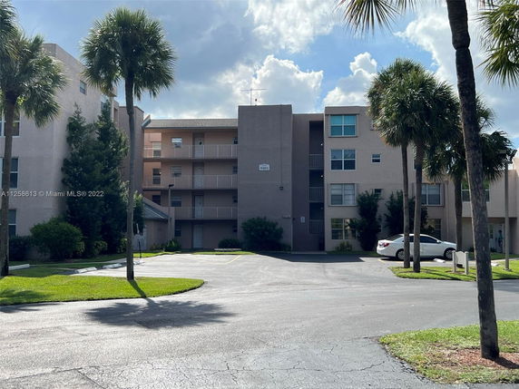 Front view of a multi-story apartment building with balconies.