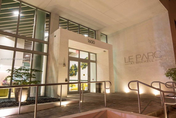 Front view of a modern building with large glass windows and entrance.