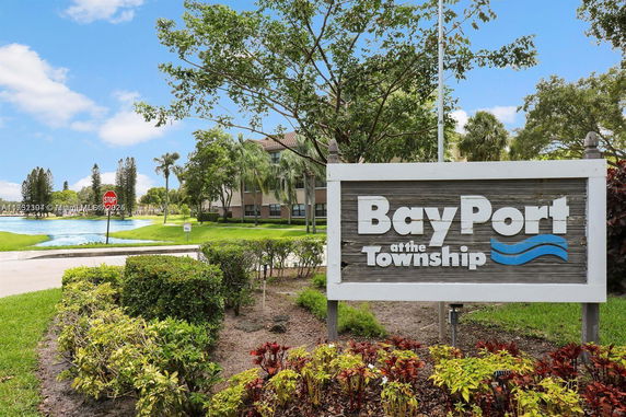 View of a building with a sign reading 'BayPort at the Township' and landscaped greenery.