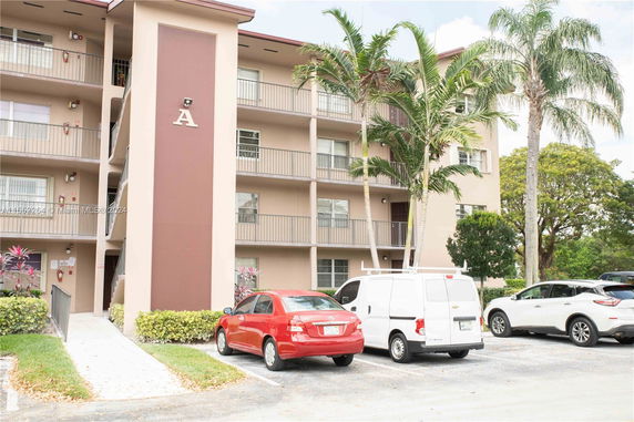 Front view of a multi-story building with balconies.
