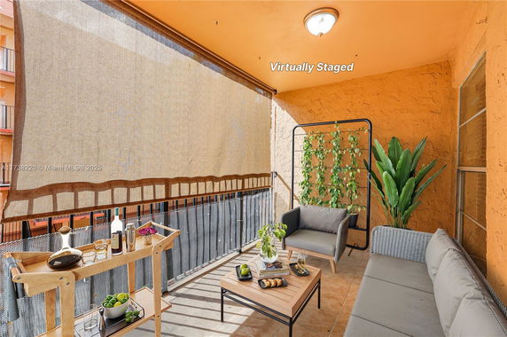 Balcony area with seating and plants in a residential building.