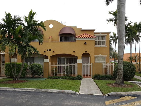 Front view of a two-story house with architectural details and gated entrance.